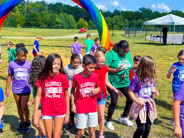 students and principal dancing outside